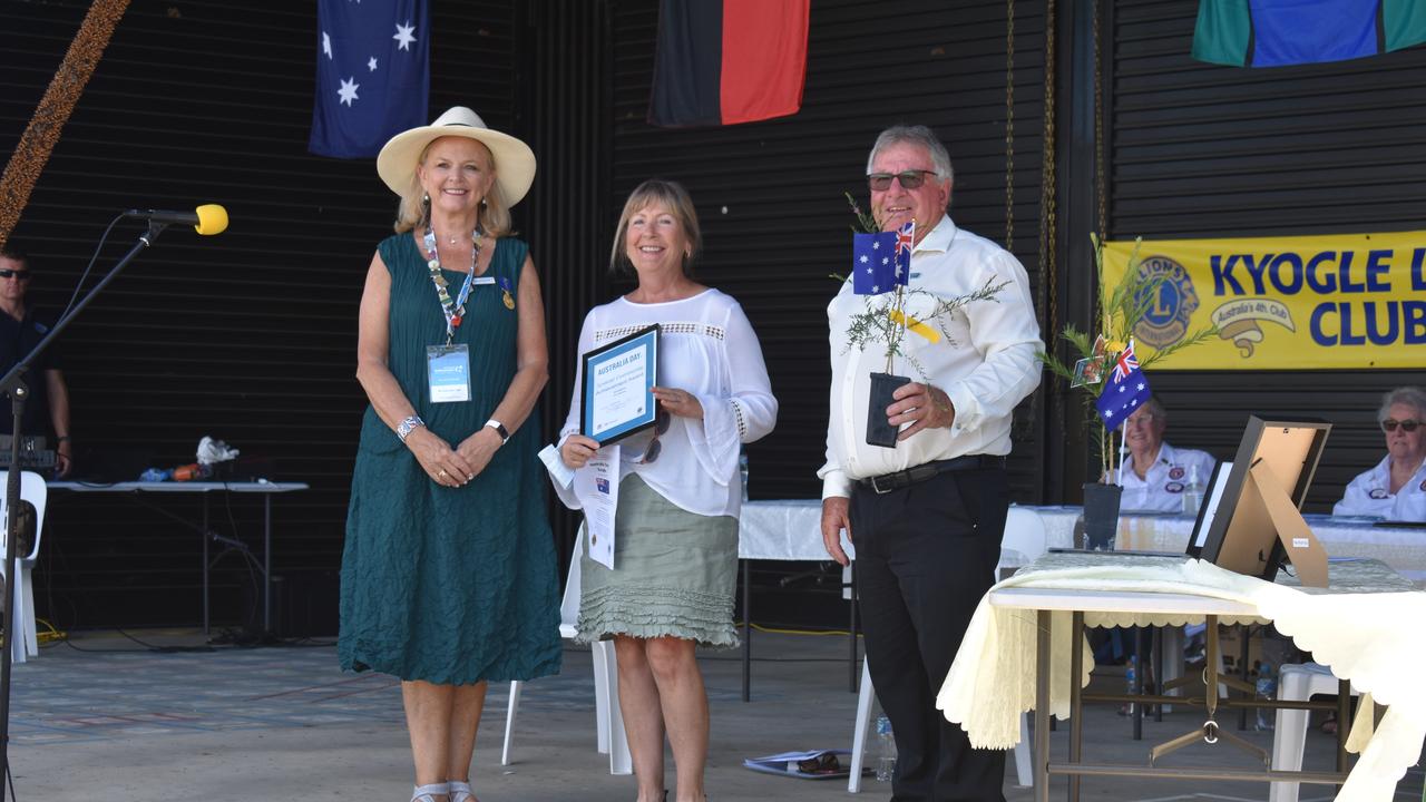 Australia Day ambassador Lyndey Milan and deputy mayor John Burley presents a posthumous special community achievement award to the family of Tom Matthew at the 2021 Kygole Australia Day ceremony.