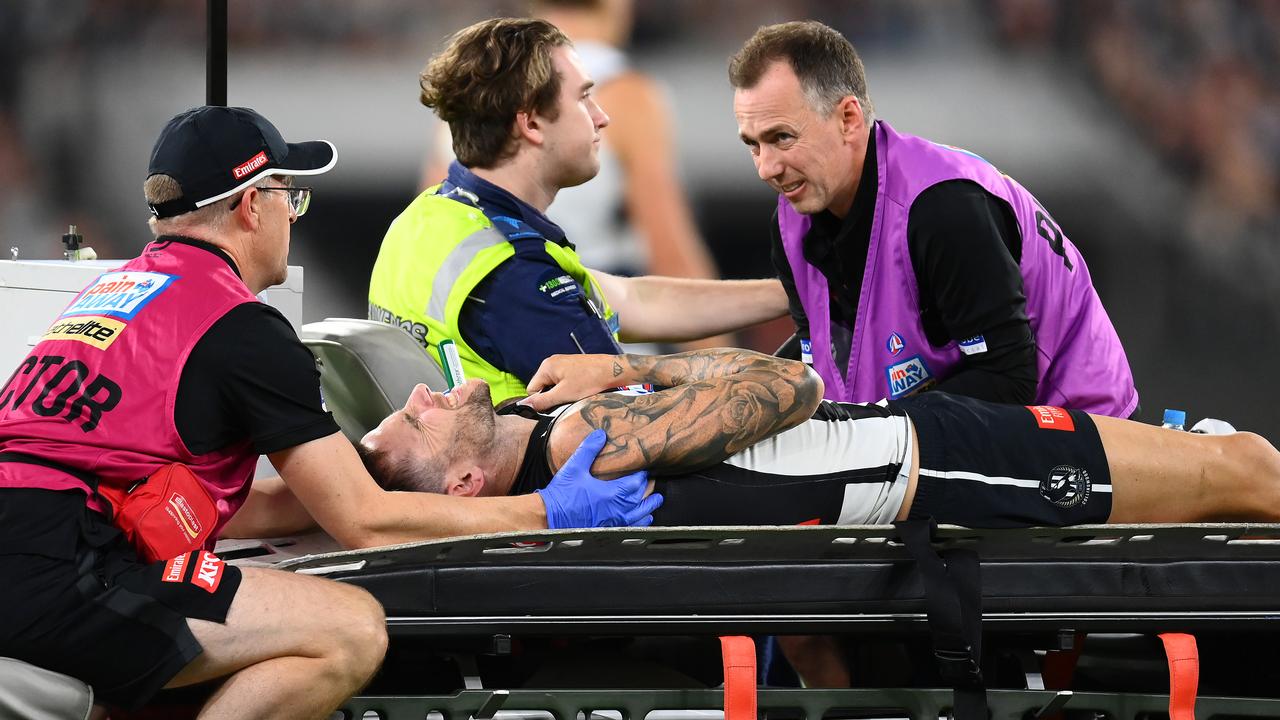 MELBOURNE, AUSTRALIA - MARCH 17: Jeremy Howe of the Magpies is taken off the ground on a stretcher during the round one AFL match between Geelong Cats and Collingwood Magpies at Melbourne Cricket Ground, on March 17, 2023, in Melbourne, Australia. (Photo by Quinn Rooney/Getty Images)