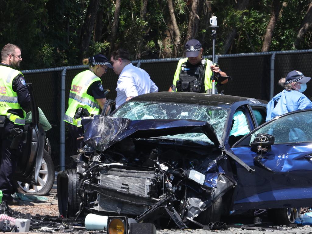 Police comb the wreckage of one of the vehicles. Picture Lachie Millard