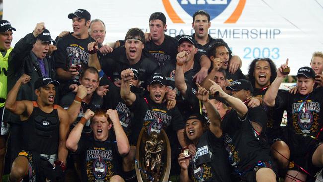 Members of the Penrith Panthers celebrate with the Telstra trophy after Penrith Panthers defeated Sydney Roosters in 2003 NRL Grand Final at Telstra Stadium, Olympic Park, Homebush in Sydney, 05/10/2003.