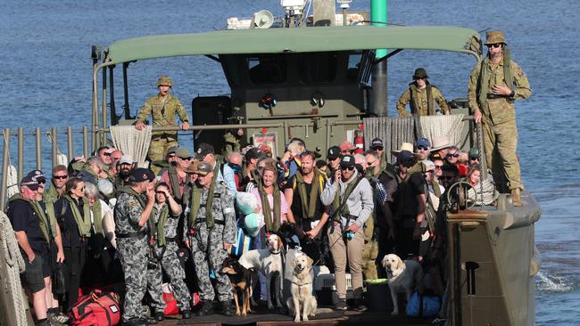 Evacuees from Mallacoota disembark at HMAS Creburus after travelling on HMAS Choules. Picture: David Geraghty.