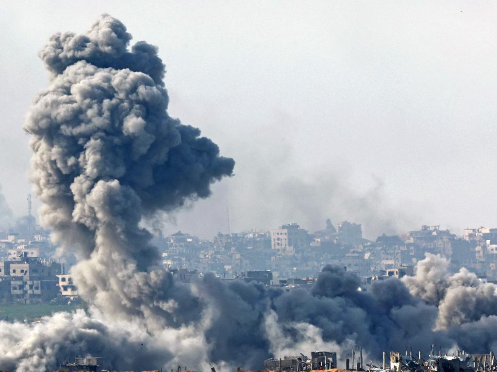 This picture taken from the Israeli side of the border with the Gaza Strip shows smoke plumes rising from explosions above destroyed buildings in the northern Gaza Strip on January 14. Picture: Jack Guez/AFP