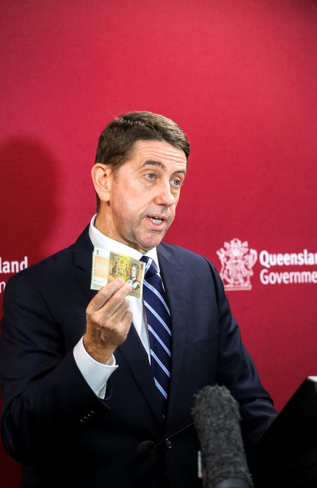 Queensland Treasurer Cameron Dick holds a $1 note from his very first pay packet. Picture: NCA NewsWire / David Kapernick