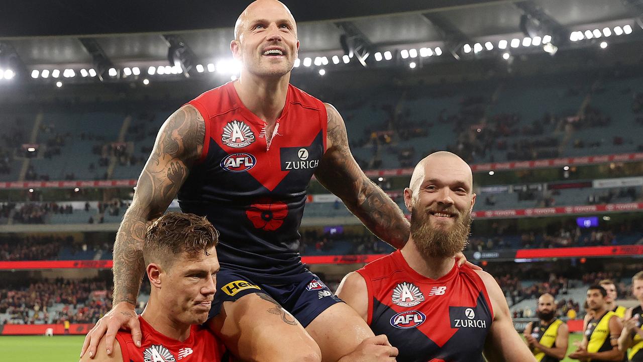 Jake Melksham (left) and Max Gawn chair off Nathan Jones last year after his 300th game for Melbourne. Picture: Michael Klein