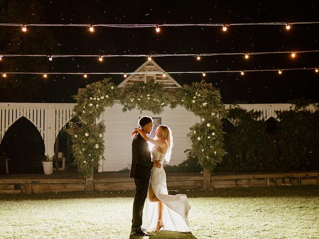 The newlyweds beneath fairy lights at the family venue.