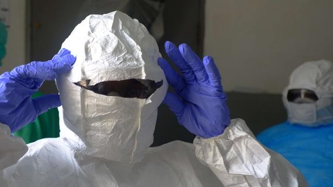 Medical workers of the John Fitzgerald Kennedy hospital of Monrovia wear their protective suit before going to the high-risk area of the hospital, the surgical section where Ebola patients are being treated, on September 3, 2014. Nurses at Liberia's largest hospital went on strike on September 1, 2014, demanding better pay and equipment to protect them against a deadly Ebola epidemic which has killed hundreds in the west African nation.AFP PHOTO / DOMINIQUE FAGET