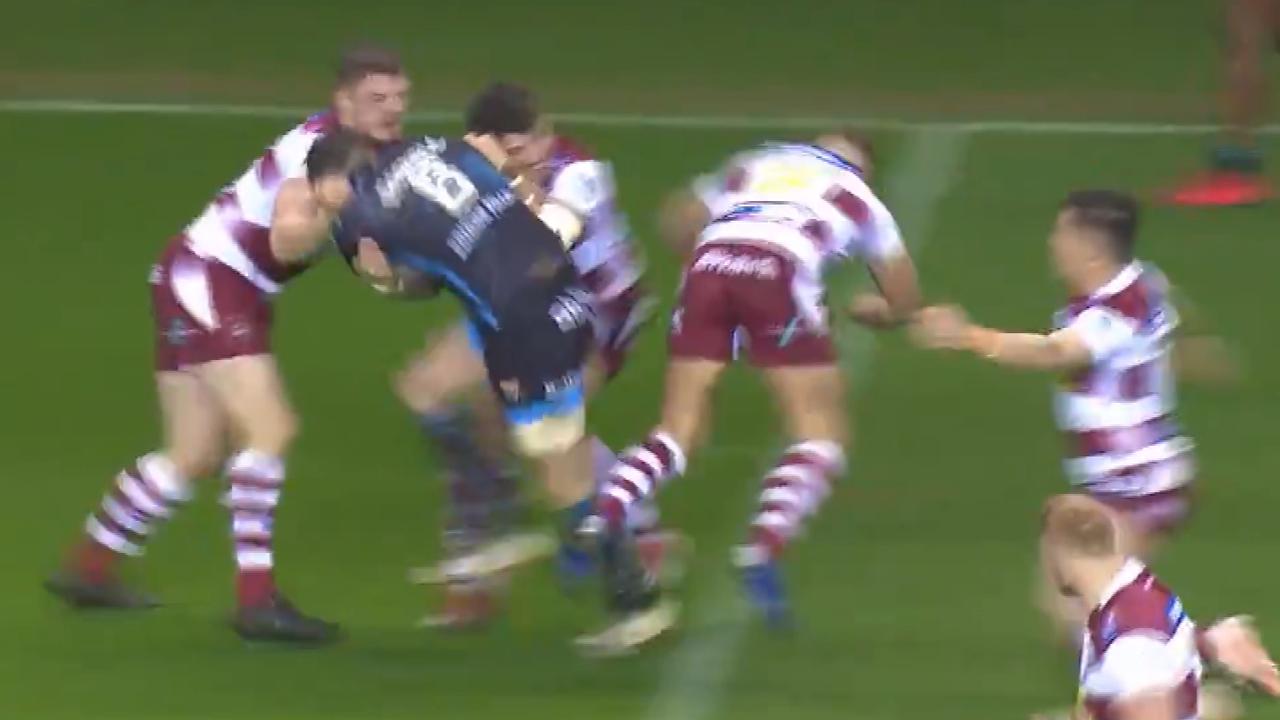 Wigan's George Williams tackles the air against Huddersfield.