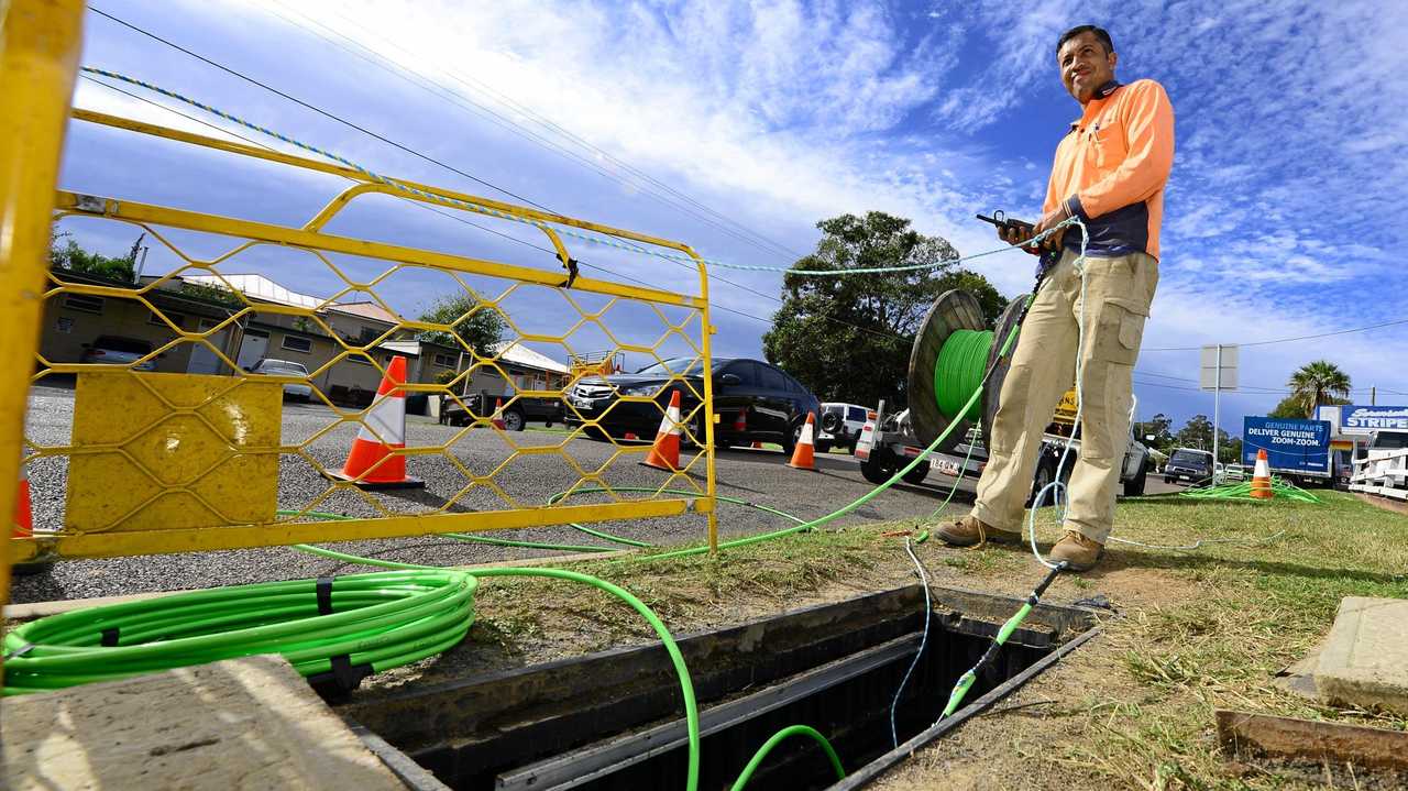 WHERE'S THE NET: A worker laying down fibre optic cable as part of the NBN rollout. Picture: David Nielsen