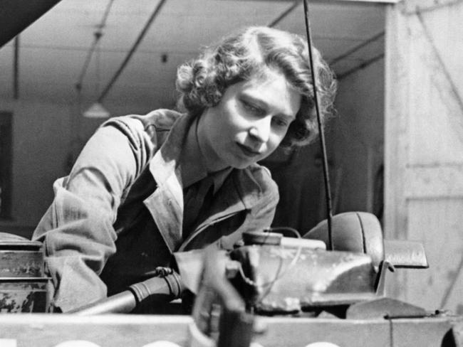 Princess Elizabeth taking out the plugs of a car during training at an A.T.S training centre, in Southern England, in 1945. Picture: AFP