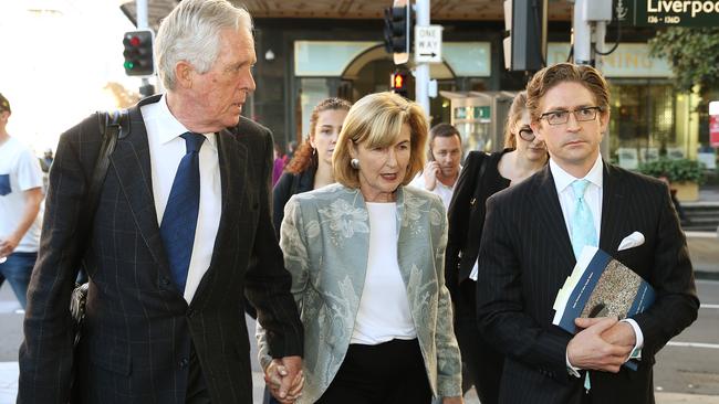 Sandy Dawson, right, walks alongside his mother Jane and father Alexander after State Coroner Michael Barnes handed down his findings into the Lindt cafe siege. Picture: Toby Zerna