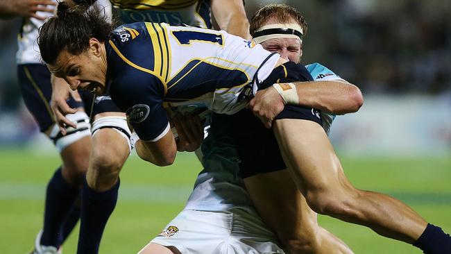 CANBERRA, AUSTRALIA - APRIL 04: Matt Toomua of the Brumbies is tackled during the round eight Super Rugby match between the Brumbies and the Cheetahs at GIO Stadium on April 4, 2015 in Canberra, Australia. (Photo by Stefan Postles/Getty Images)