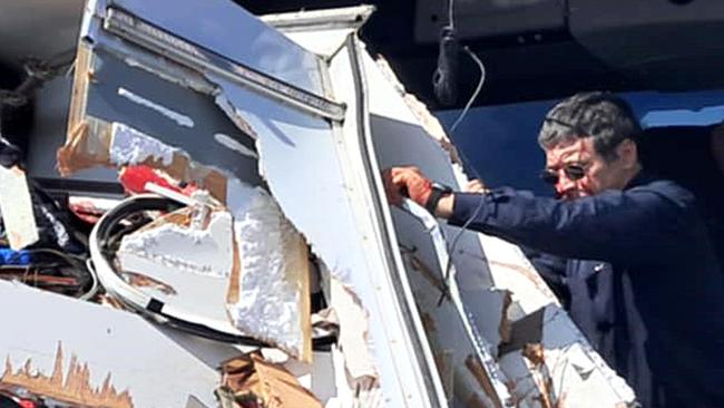 Supplied image from a passenger of a Greyhound bus and caravan crash near Gumlu. The bus driver looking out at the damage after the crash.