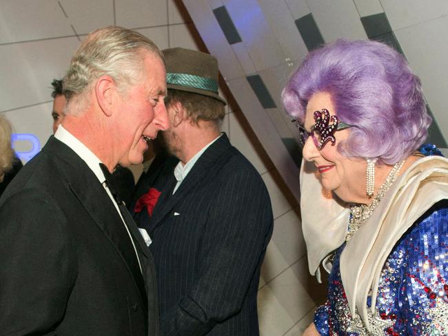 (FILES) In this file photo taken on November 25, 2013, Australian comedian, actor and author Australian Barry Humphries, as his alter ego, Dame Edna Everage (R), speaks to the then Prince Charles, as he attends the Royal Variety Performance at the London Palladium Theatre. - Humphries died on April 22, 2023 in a Sydney hospital, prompting a tribute from the prime minister who described him as "the brightest star". (Photo by ARTHUR EDWARDS / POOL / AFP)