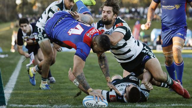 Manlyâ€™s Jay Baker leaps over Warringahâ€™s Luke Reimer to touch down as Harry Jones swoops in. Warringah v Manly (Northern Beaches Derby 2), Shute Shield Rd 16 at Pittwater Rugby Park. Rats def Marlins 28-23. Saturday 20th July 2019.  Â© Karen Watson