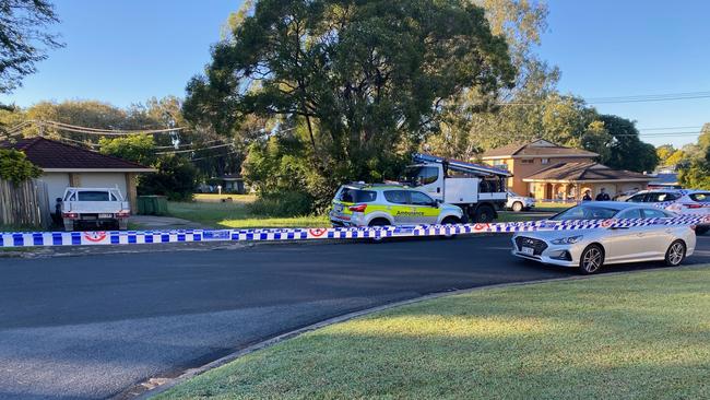 Police have cordoned off Mahogany St at Raceview following a house fire and disturbance early Friday morning in which a man was seriously injured. Picture: Lachlan McIvor