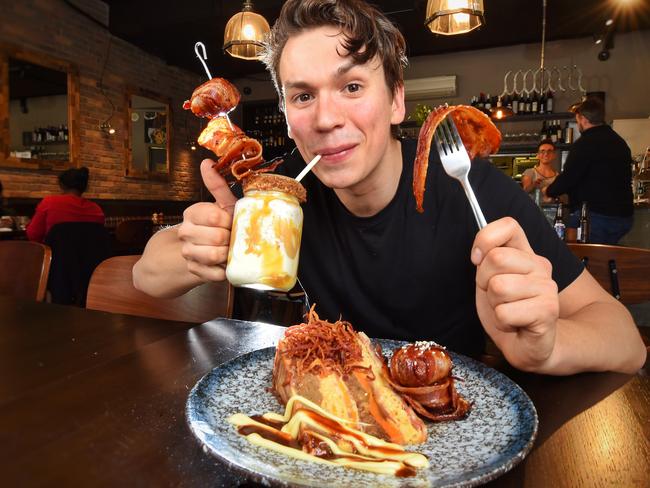 Jurek Osada gets stuck into a Bacon Cake and a Bacon Milkshake at the Third Wave Cafe in Port Melbourne. Picture: Tony Gough