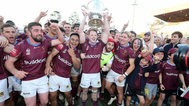 Queensland University celebrate their grand final win. Photo: AAP Image/Richard Gosling