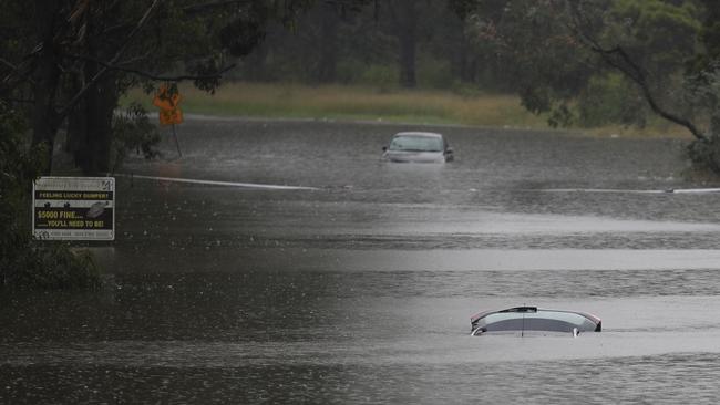 Flooding in western Sydney off Blacktown Road between Windsor and Richmond, where cars are waterlogged and homes and businesses have been swamped. Picture: John Grainger