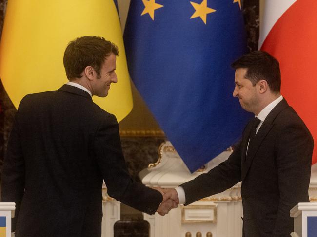 Emmanuel Macron Ukrainian president Volodymyr Zelensky shake hands in Kyiv in February, 2022. Picture: Getty Images