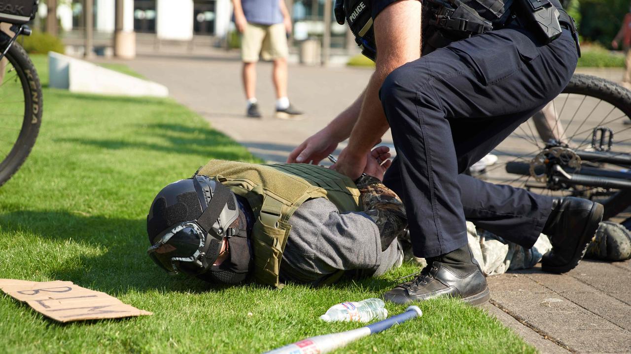 A Proud Boys member being arrested by police. Picture: Allison Dinner/AFP