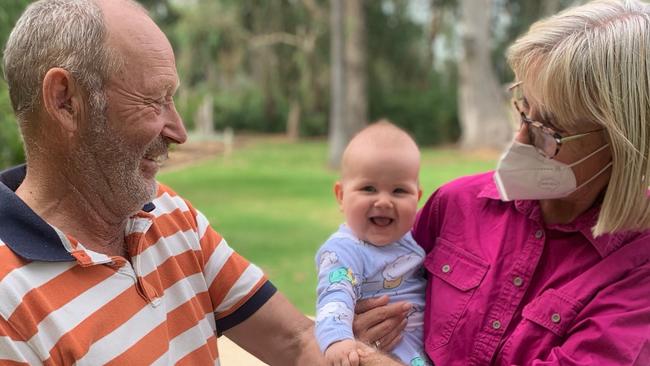 Stuart Pitson, who has been living with MND for six years, pictured with wife Julie and granddaughter Hallie.