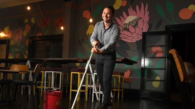 Riley Walter tries his hand at bar work/cleaning at the Franklin Hotel in the city. Picture: Tricia Watkinson