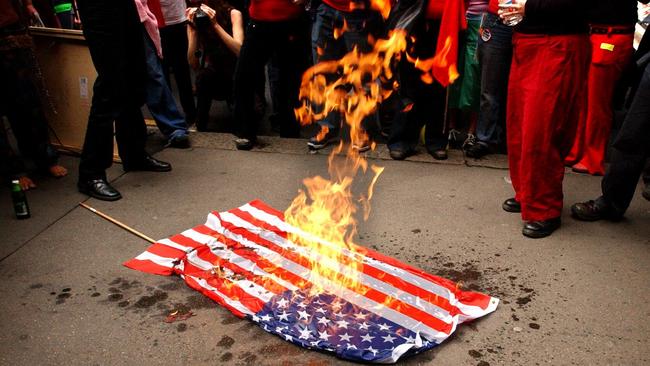 An American flag is burnt during a march against the Informal World Trade Organisation (WTO) meeting in Sydney in 2002.