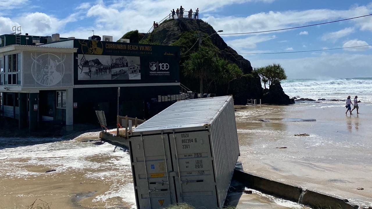 A shipping container used to store gear at Currumbin Surf Club has been washed into the surf. Picture: Steve Shield