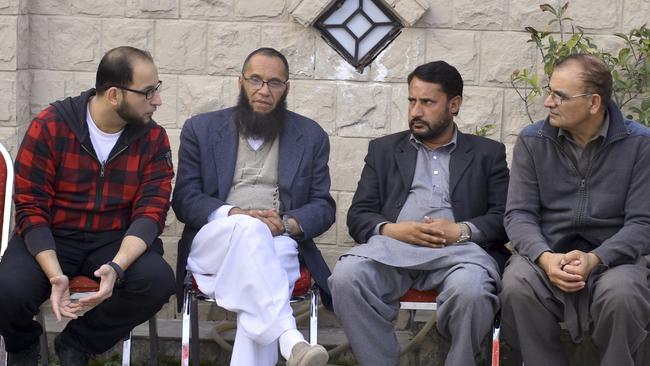 Relatives talk to Nadeem Rashid, second left, bother of a Pakistani citizen Rashid Naeem, who was killed along with and his son Talha Naeem in the Christchurch mosque shooting. Picture: AP