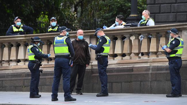 Police conducting spot checks in the Melbourne CBD on Sunday. Picture: AFP