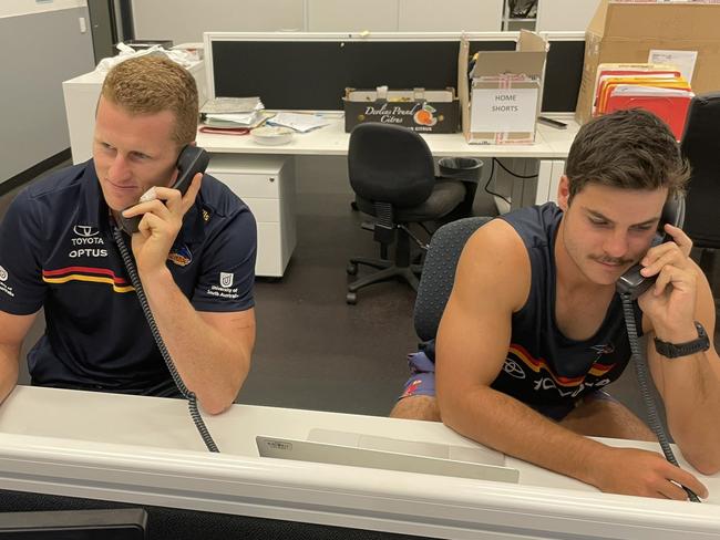 CROWS TICKET/SEATS COVID BLUNDER. Crows players take to the phone to call affected ticket holders. Picture: Adelaide Crows/Twitter