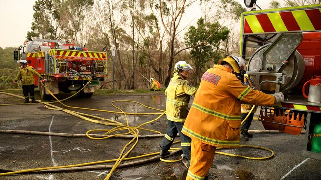 NSW Rural Fire Service crews mop up after the South Turramurra fire came close to homes in November last year. Picture: AAP