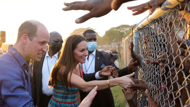 Prince William, Duke of Cambridge and Catherine, Duchess of Cambridge shake hands with children during a visit to Trench Town. Picture: Chris Jackson-Pool/Getty Images.