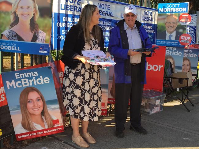 “Just talk to Jackie,” a dismissive Ms McBride hands out how-to-vote cards at Brooke Avenue Public School this morning. Picture: Richard Noone