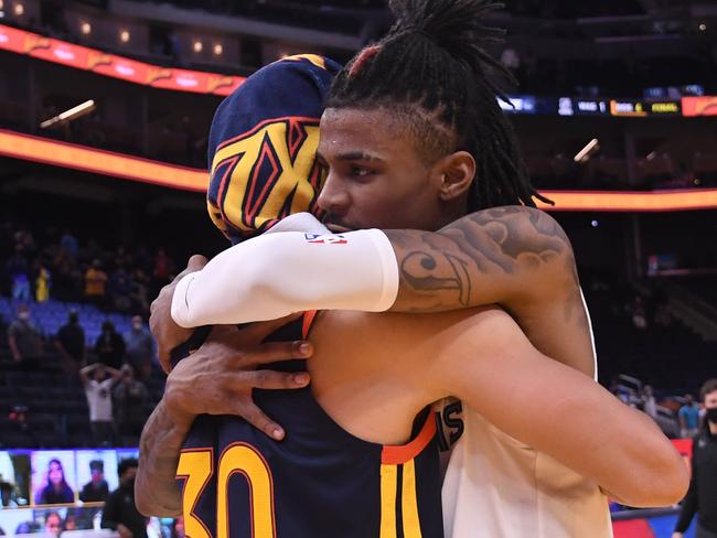 SAN FRANCISCO, CA - MAY 21: Ja Morant #12 of the Memphis Grizzlies hugs Stephen Curry #30 of the Golden State Warriors after the 2021 NBA Play-In Tournament on May 21, 2021 at Chase Center in San Francisco, California. NOTE TO USER: User expressly acknowledges and agrees that, by downloading and or using this photograph, user is consenting to the terms and conditions of Getty Images License Agreement. Mandatory Copyright Notice: Copyright 2021 NBAE (Photo by Noah Graham/NBAE via Getty Images)