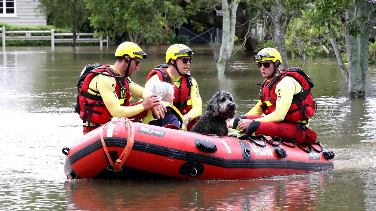 Floods in NSW and Queensland are affecting many people right now but there’s help for those in need like Lynne Gosse and her dog, Poppy, who were rescued by emergency workers in a boat. Picture: Steve Pohlner