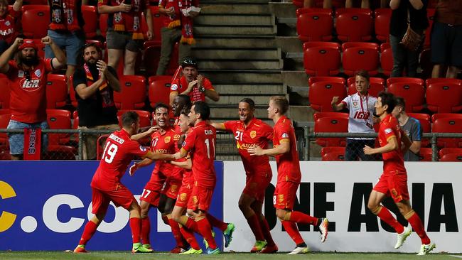 Adelaide United celebrate a goal.