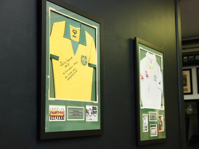 Clothing worn by former student Garry Manuel, who played football for Australia as part of the 1974 Socceroos World Cup squad, and Jeff Thomson, who played cricket for Australia, adorns the school reception area. Picture: Richard Dobson