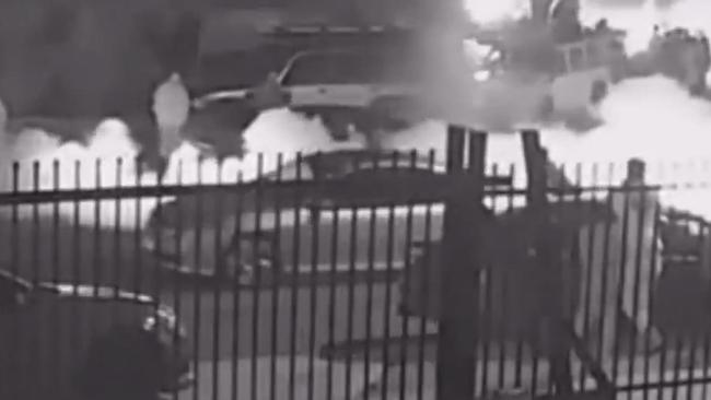 CCTV captures smoke billowing from cars performing burnouts on Harrick Road, Keilor Park during a gathering last night.