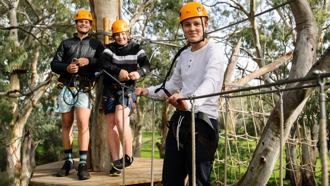 Sam, 14, Seb, 14, and Charlie, 15, enjoying TreeClimb Adelaide. Picture: Morgan Sette