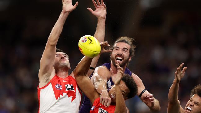 Logan McDonald of the Swans and Alex Pearce of the Dockers in action . (Photo by Will Russell/AFL Photos via Getty Images)