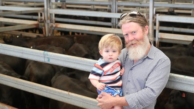 Alistair McKenzie-McHarg and his son Liam, 18 months old from Bullioh, selling 40 steers. Picture: Yuri Kouzmin