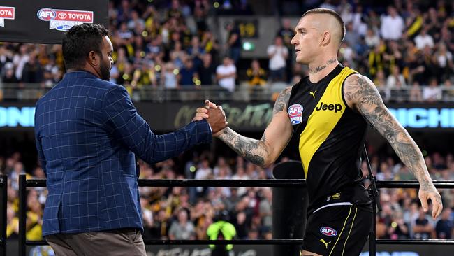 Dustin Martin is presented the Norm Smith Medal by Byron Pickett.