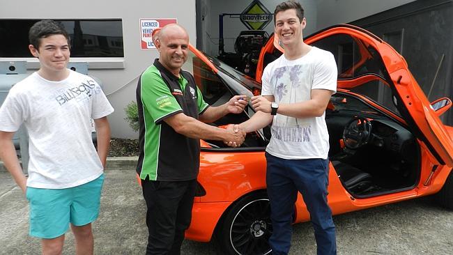 Castle Hill-based Body Tech Automotive owner Peter Christodoulou hands the keys of the Toyota Sera to Jarrod Lawrence, 19, from Liverpool. Picture: WARREN THOMSON.