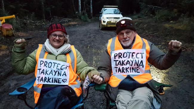 Jill Pierce and Craig Brown block the road in the rainforest near Rosebery