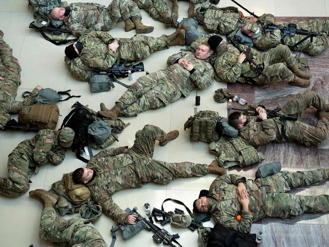 Members of the National Guard rest in the Capitol Visitors Center on Capitol Hill in Washington. Picture: AFP