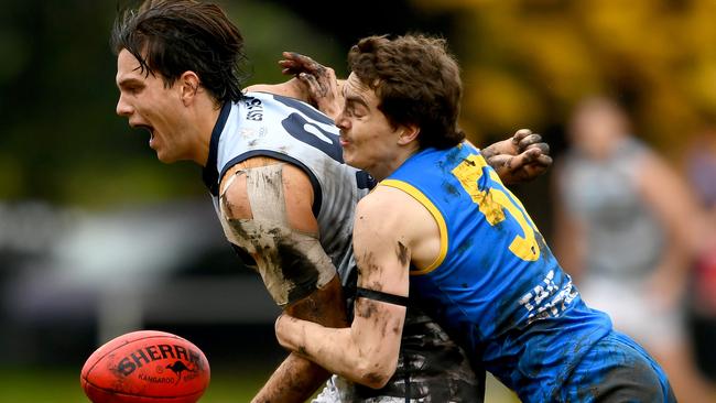 Lachlan Dunell of Old Geelong is tackled by Joshua Cumberlidge of De La Salle during the round eight 2023 Premier B Men's match between De La Salle and Old Geelong at Waverley Oval in Malvern East, Victoria on June 3, 2023. (Photo by Josh Chadwick)