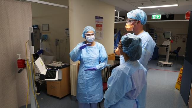 Intensive Care Specialist Dr Tim Southwood (centre) with nurses Britney Avery and Judy Lou, in the Royal Prince Alfred Hospital COVID-19 health facilities. Picture Rohan Kelly