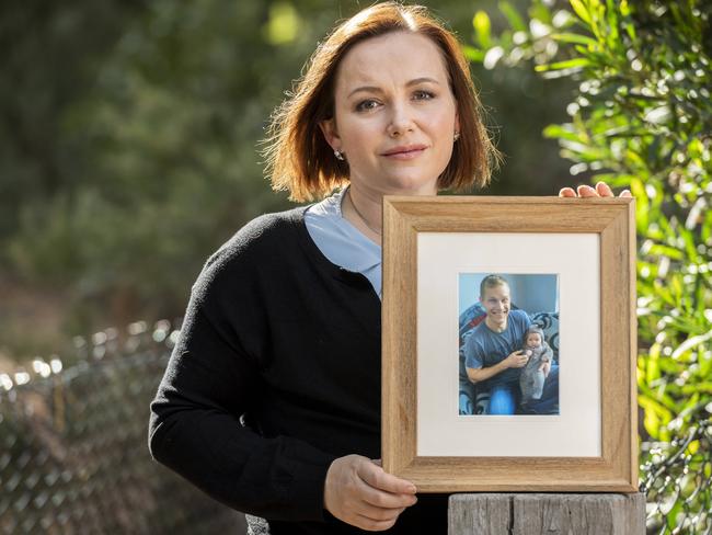 New research from the Baker Institute is showing sudden cardiac death costs the economy $2 billion annually. Mum-of-two Jessica is the human face of this; Her husband Bryan died at home, unexpectedly when she was breastfeeding their first child six years ago. Jessica holds a picture of her late husband Bryan and daughter Avie. Picture: Jake Nowakowski.