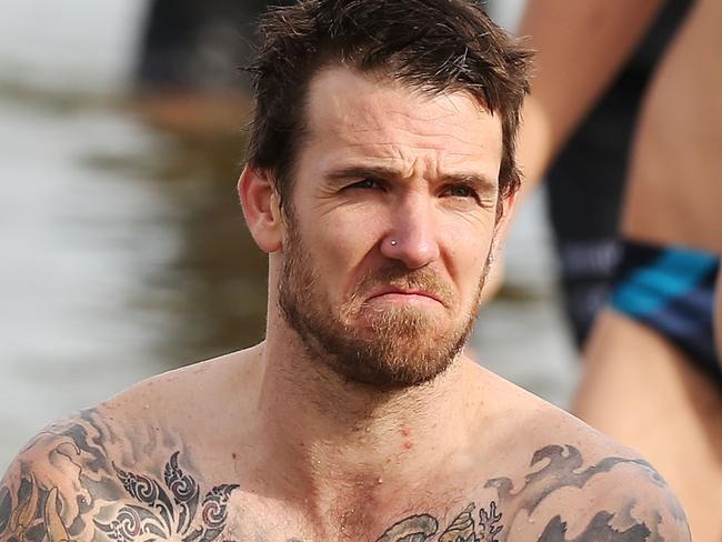 MELBOURNE, AUSTRALIA - JULY 14:  Dane Swan of the Magpies reacts as he walks out of the water during a Collingwood Magpies AFL recovery session at St Kilda Beach on July 14, 2014 in Melbourne, Australia.  (Photo by Michael Dodge/Getty Images)